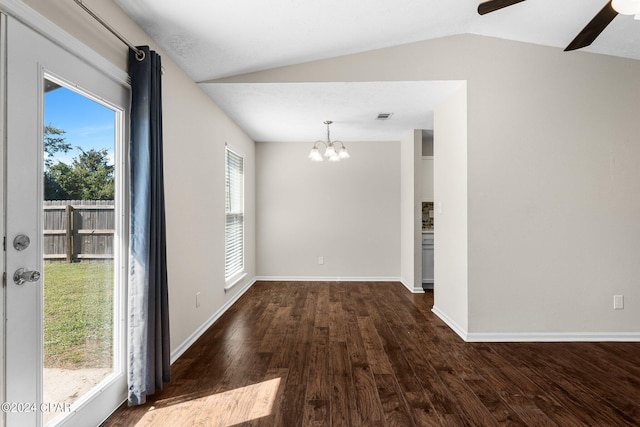 unfurnished dining area featuring ceiling fan with notable chandelier, vaulted ceiling, and dark hardwood / wood-style floors