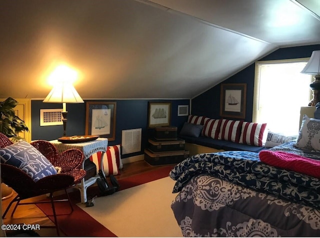 bedroom featuring lofted ceiling and hardwood / wood-style flooring