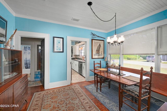 dining room with a notable chandelier and crown molding