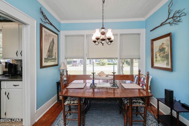 dining room featuring dark hardwood / wood-style flooring, a notable chandelier, and ornamental molding