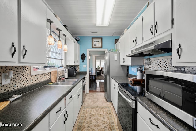 kitchen with backsplash, sink, hanging light fixtures, white cabinetry, and stainless steel appliances