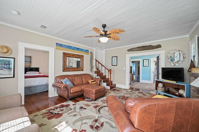 living room with dark hardwood / wood-style flooring, ceiling fan, and ornamental molding