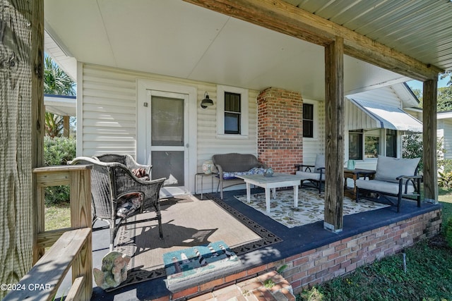 wooden terrace with an outdoor living space and a patio