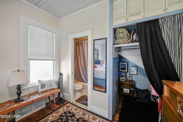 interior space featuring wood-type flooring and crown molding