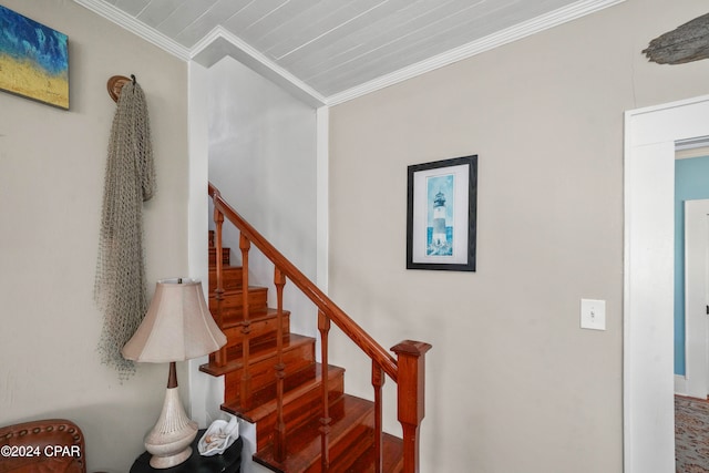 stairs with wood-type flooring and crown molding