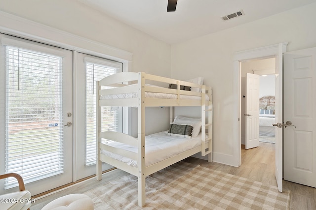 bedroom with multiple windows, ceiling fan, and light hardwood / wood-style flooring