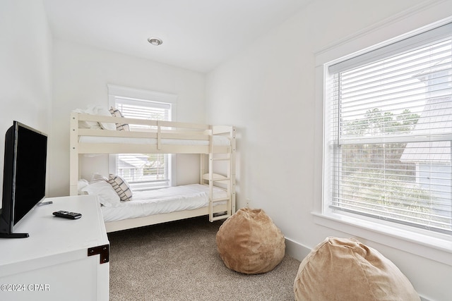 bedroom with multiple windows and carpet flooring