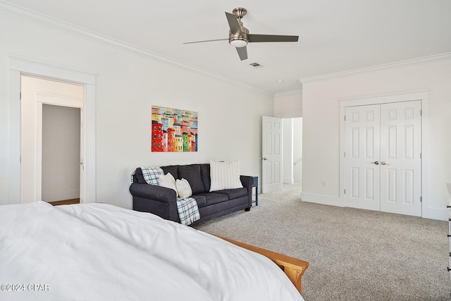 bedroom featuring ceiling fan, carpet flooring, a closet, and crown molding