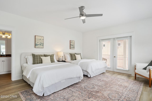 bedroom featuring hardwood / wood-style flooring, ceiling fan, multiple windows, and access to outside