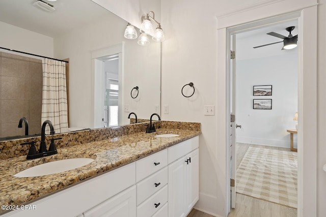 bathroom with ceiling fan, wood-type flooring, and vanity