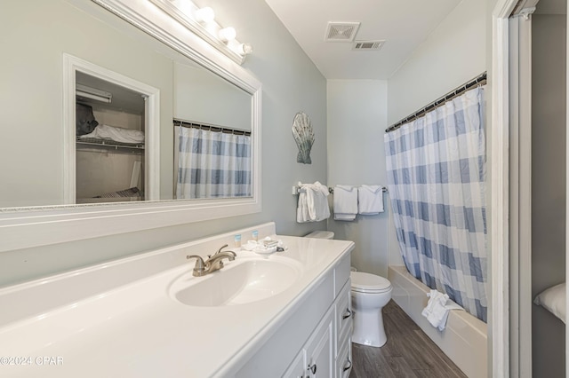 full bathroom with hardwood / wood-style flooring, shower / bath combination with curtain, toilet, and vanity