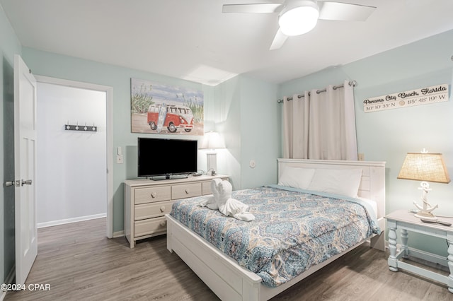 bedroom with ceiling fan and hardwood / wood-style floors