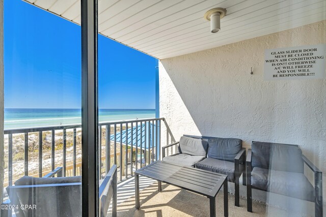 balcony with a beach view and a water view