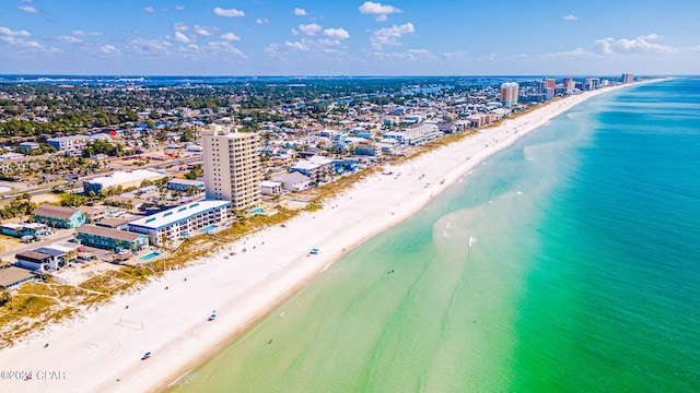 bird's eye view featuring a water view and a beach view