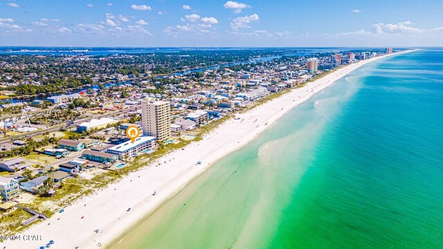 bird's eye view with a water view and a beach view