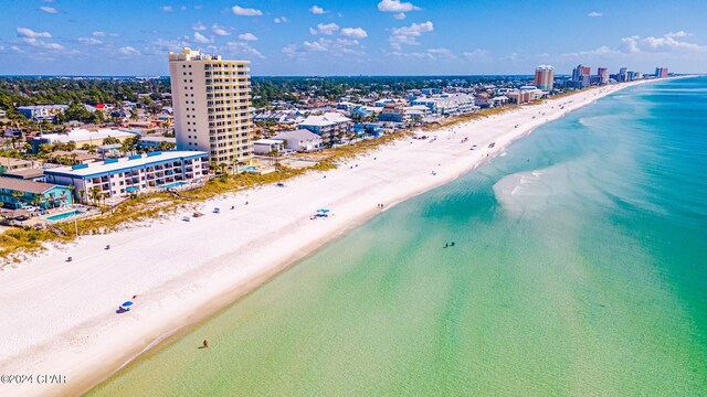 bird's eye view featuring a view of the beach and a water view