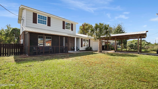 view of front of house with a front yard and a sunroom