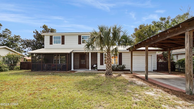 view of front of property with a sunroom, a garage, and a front yard