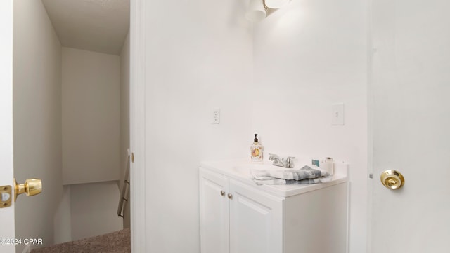 interior space with white cabinetry and sink