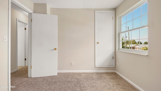 unfurnished bedroom with light colored carpet