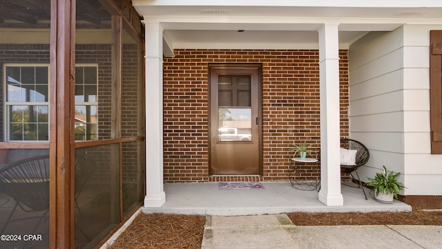 entrance to property with covered porch and french doors