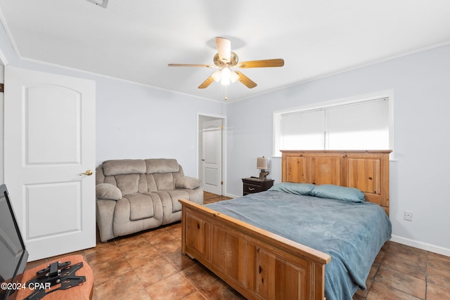 bedroom with baseboards, ceiling fan, and crown molding