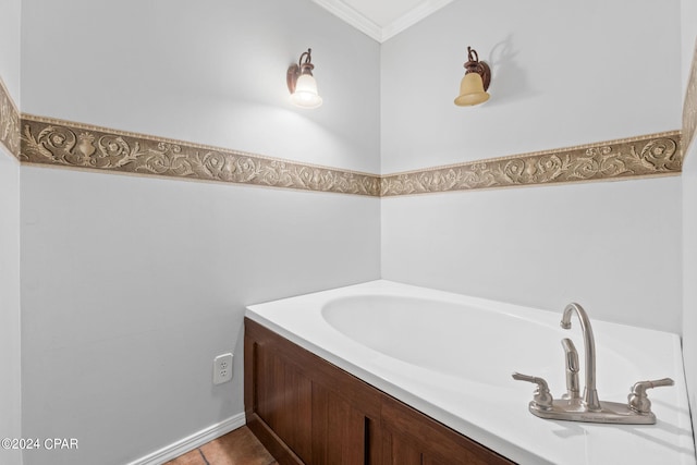 full bath featuring ornamental molding and a garden tub