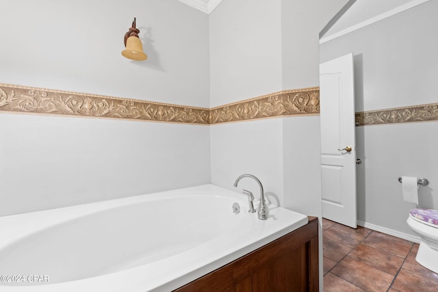 bathroom with crown molding, toilet, and a garden tub