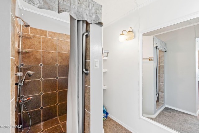 bathroom featuring baseboards and tiled shower