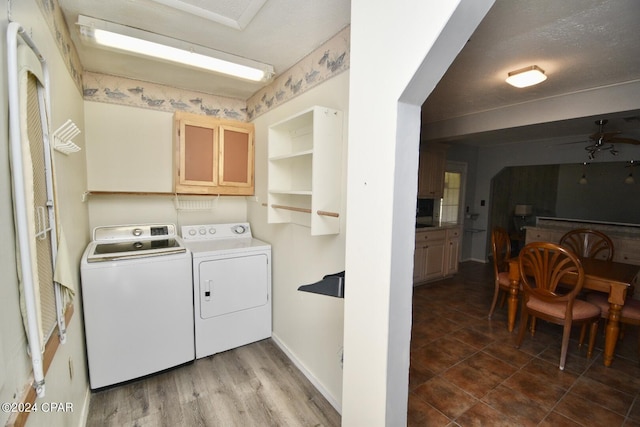 laundry area with washing machine and clothes dryer, baseboards, and laundry area