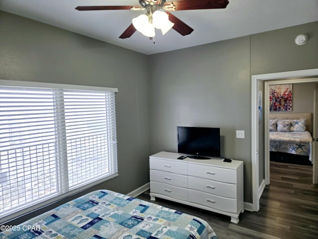 bedroom with ceiling fan and dark hardwood / wood-style flooring