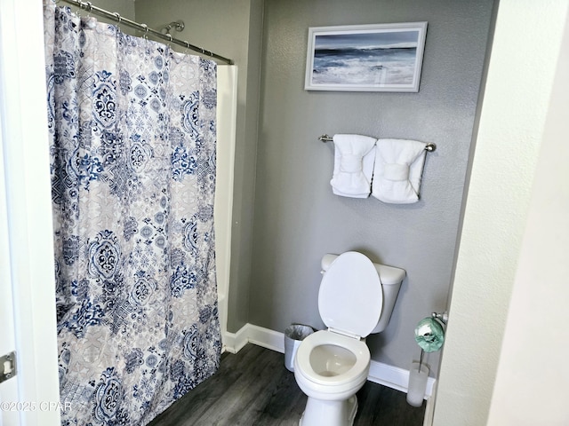 bathroom featuring wood-type flooring, toilet, and walk in shower