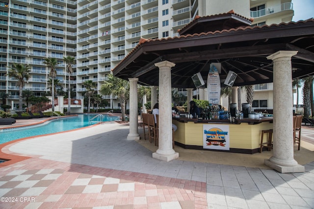 view of pool featuring a gazebo and an outdoor bar