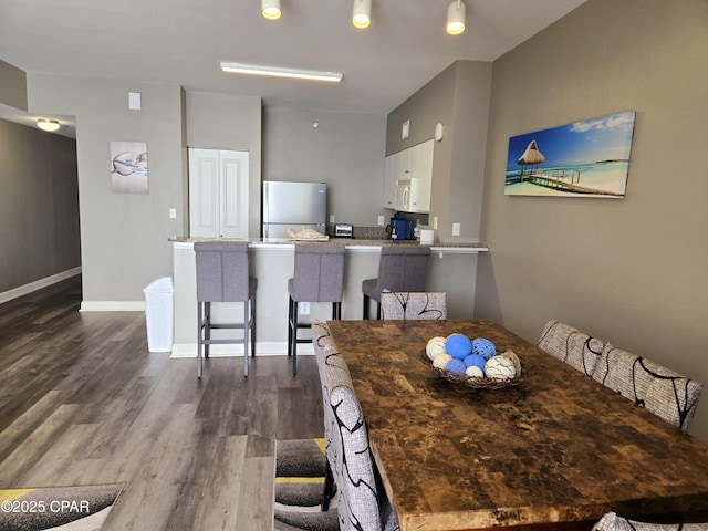 dining area with dark wood-type flooring