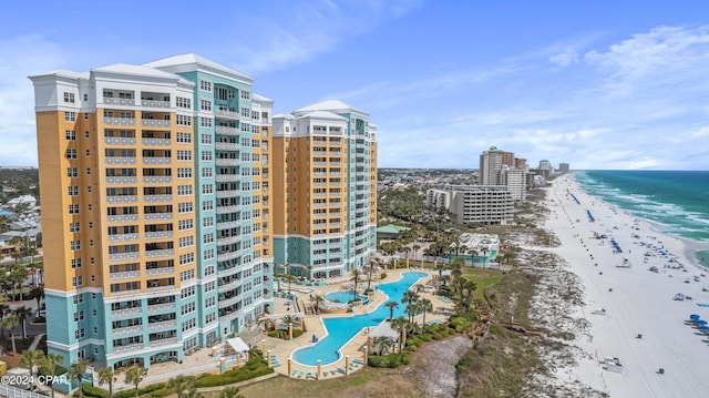 view of property featuring a water view and a beach view