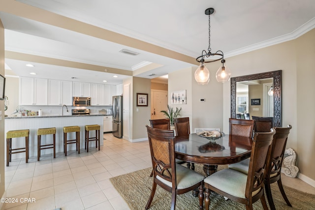 tiled dining area featuring ornamental molding and sink