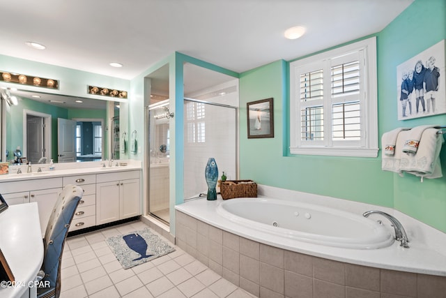 bathroom featuring shower with separate bathtub, vanity, and tile patterned floors