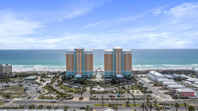 aerial view with a water view and a beach view