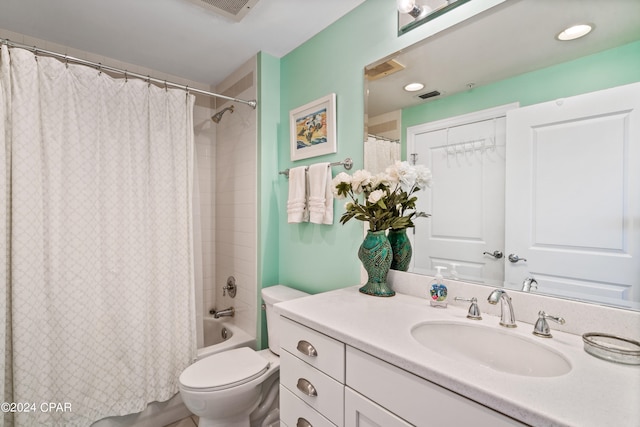 full bathroom featuring shower / bath combo, vanity, and toilet