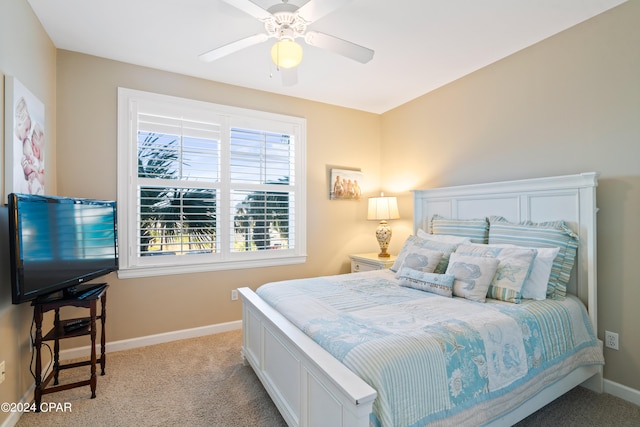 bedroom with ceiling fan and light carpet