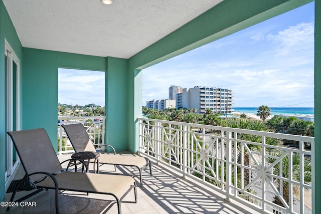 balcony featuring a water view