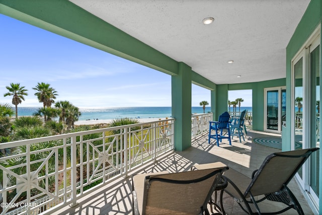 balcony with a view of the beach and a water view