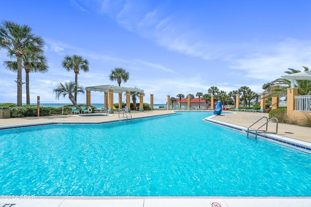 view of swimming pool featuring a pergola and a patio area