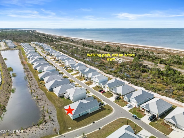 bird's eye view featuring a water view, a residential view, and a view of the beach