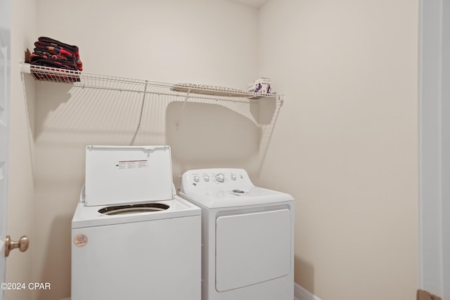 clothes washing area featuring independent washer and dryer