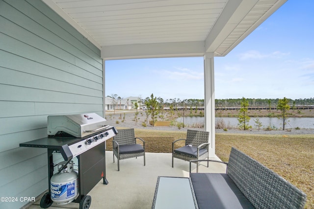 view of patio / terrace with a water view, grilling area, and an outdoor living space