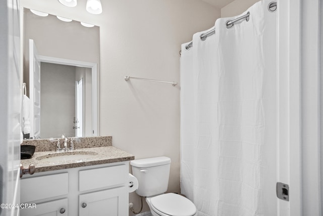 full bathroom with toilet and vanity