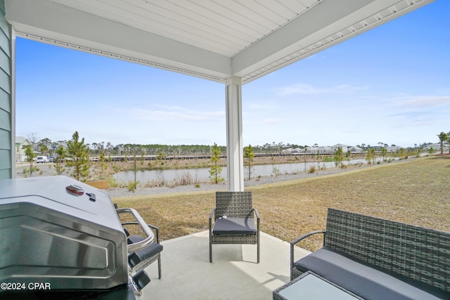 view of patio / terrace with a water view and grilling area