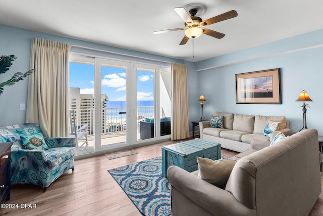 living room featuring light wood-type flooring and ceiling fan