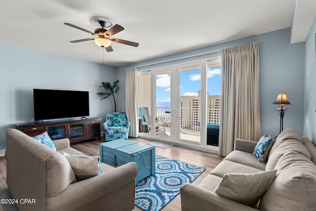 living room featuring light wood-type flooring and ceiling fan